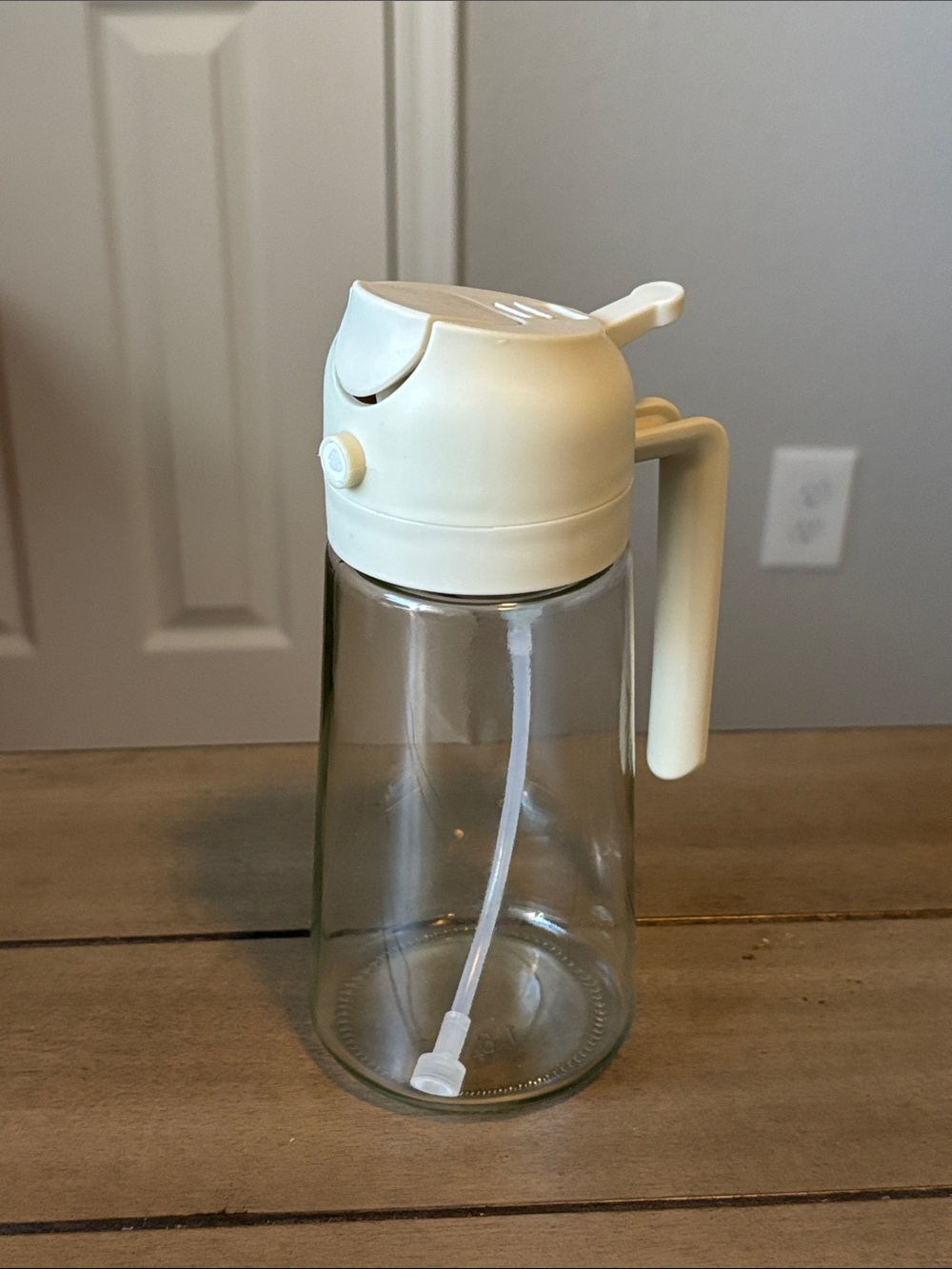 242. Glass oil dispenser with taupe pour / spray top